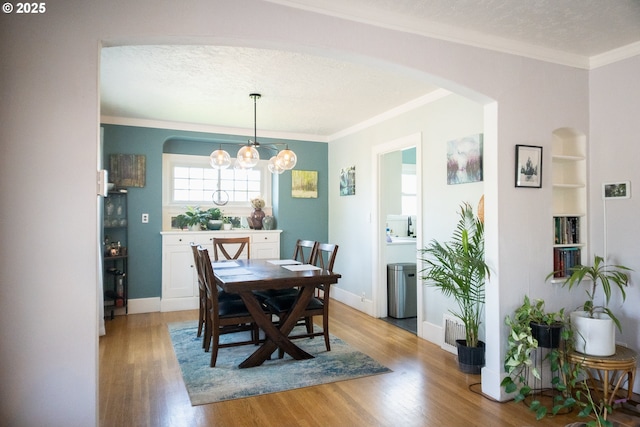 3710 SE 86th Ave, Portland, OR 97266 - dining room with arched walkways, light wood-type flooring, ornamental molding, a chandelier, and a textured ceiling