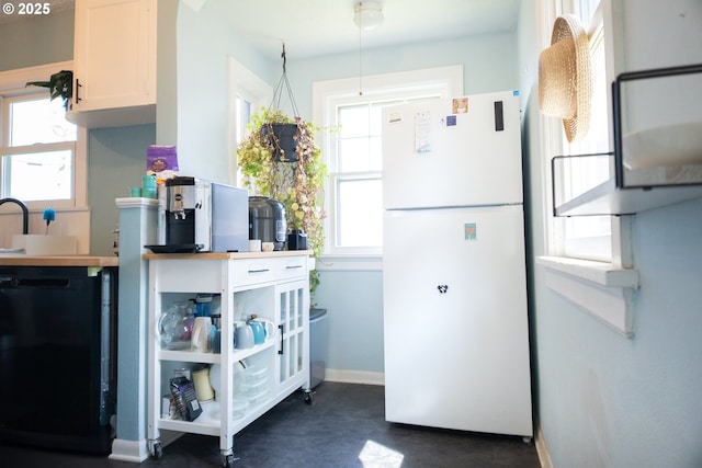3710 SE 86th Ave, Portland, OR 97266 - kitchen with freestanding refrigerator, concrete flooring, baseboards, arched walkways, and dishwasher