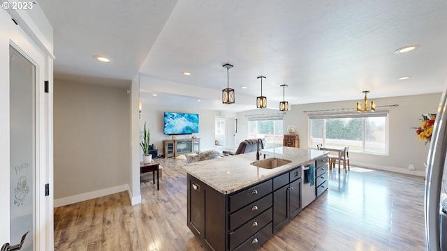97997 Olsen Ln, Brookings, OR 97415 - kitchen with a sink, baseboards, light wood-style flooring, decorative light fixtures, and recessed lighting