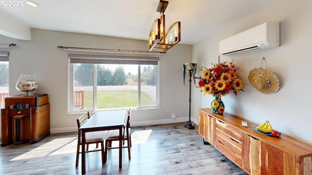 97997 Olsen Ln, Brookings, OR 97415 - dining space with a wall mounted air conditioner, light wood finished floors, and baseboards