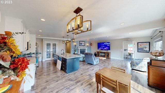 97997 Olsen Ln, Brookings, OR 97415 - kitchen featuring french doors, white cabinetry, open floor plan, recessed lighting, and a fireplace