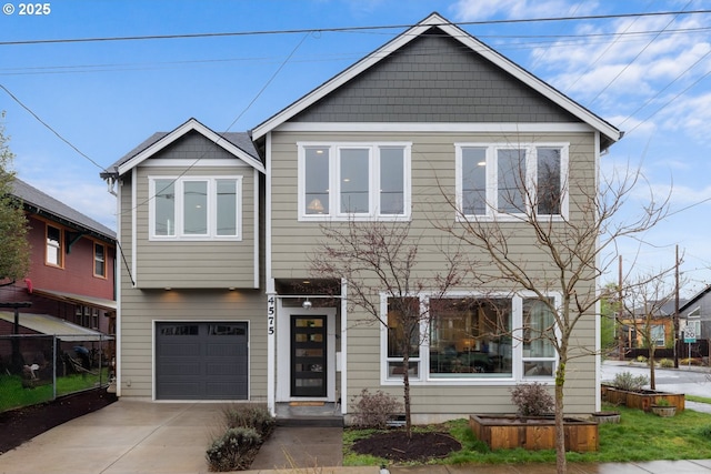 view of front of property with an attached garage and concrete driveway