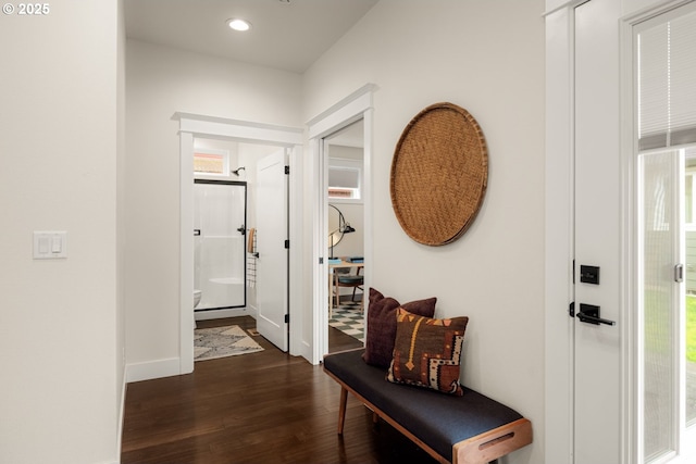 corridor with recessed lighting, baseboards, a healthy amount of sunlight, and dark wood-style floors