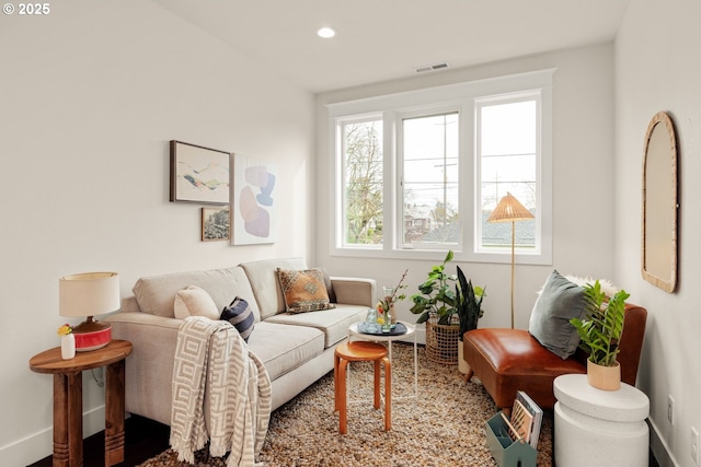 living room featuring recessed lighting, visible vents, and baseboards