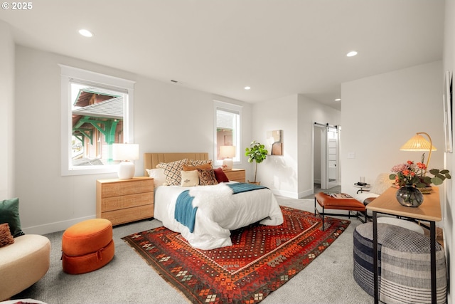 carpeted bedroom with a barn door, recessed lighting, and baseboards