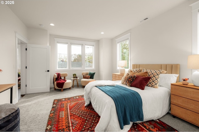 carpeted bedroom with visible vents and recessed lighting