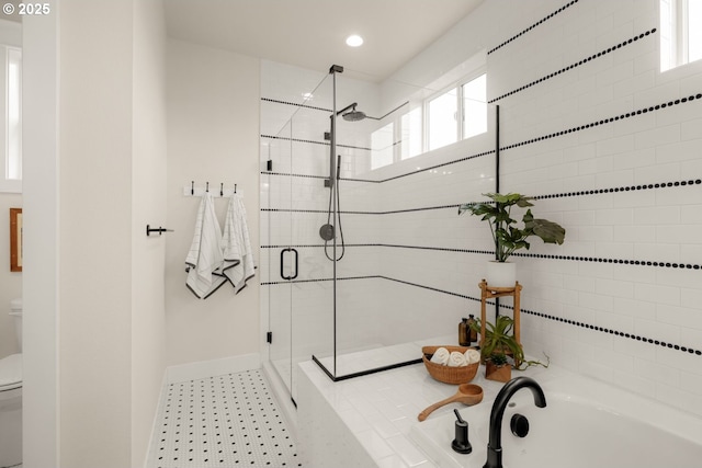 full bath with baseboards, a shower stall, toilet, and a garden tub