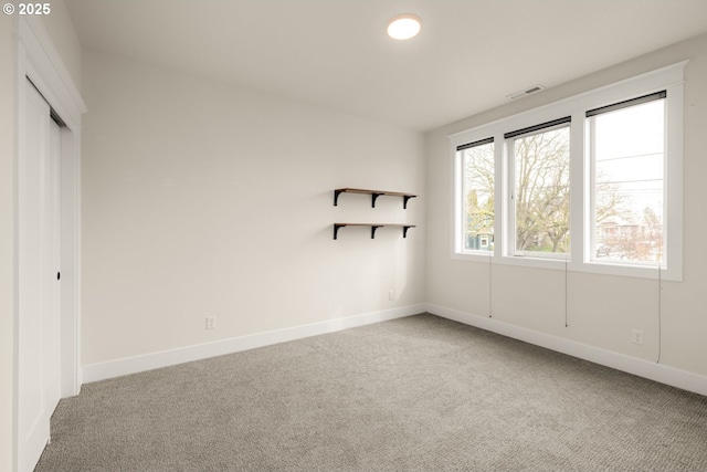 unfurnished bedroom featuring visible vents, carpet floors, baseboards, and a closet