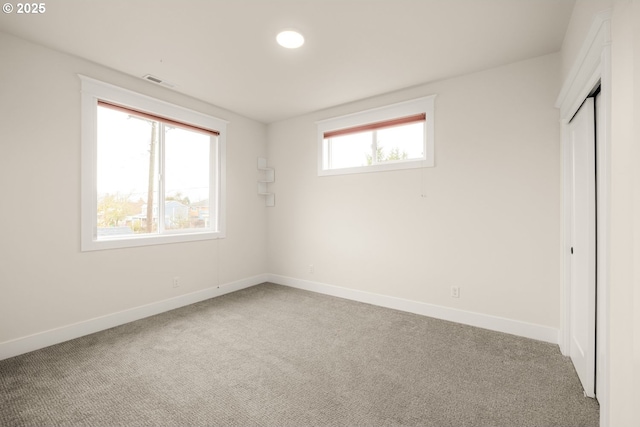 unfurnished bedroom with baseboards, visible vents, and carpet floors