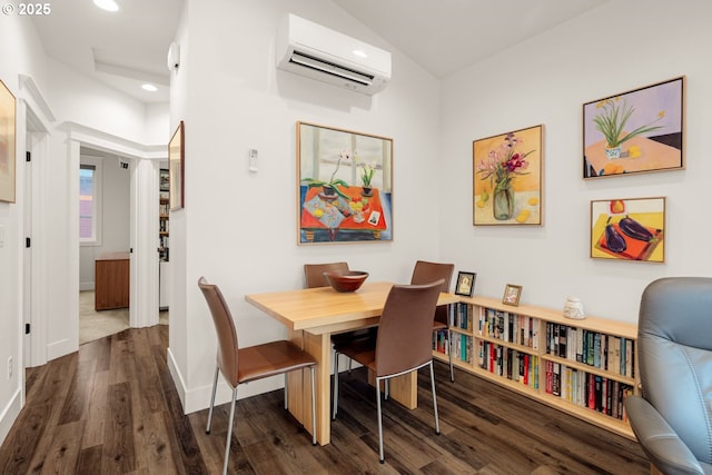 dining space featuring dark wood finished floors, recessed lighting, an AC wall unit, and baseboards