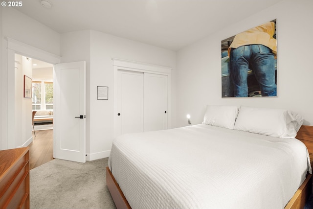 bedroom featuring a closet, carpet flooring, and baseboards