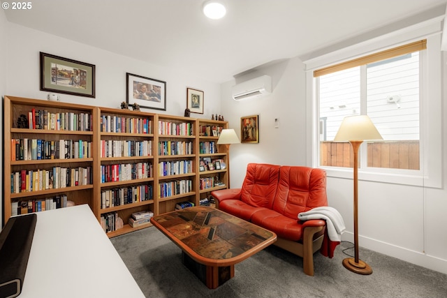 living area with a wall unit AC, baseboards, and carpet floors