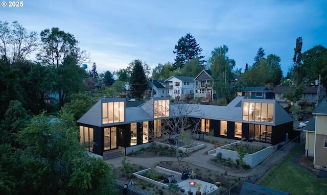 back of house featuring a garden