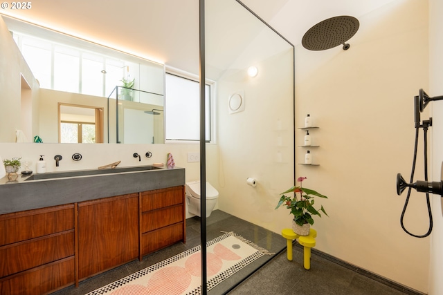 full bath with toilet, vanity, and a shower