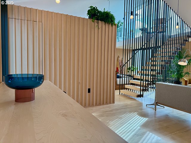 living area featuring stairs, high vaulted ceiling, and wood finished floors