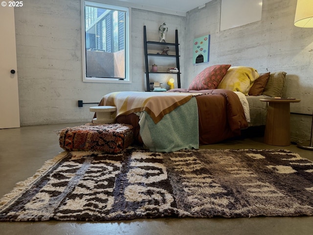 bedroom featuring finished concrete flooring