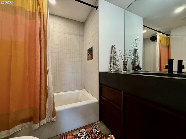 bathroom with shower / bath combo and vanity