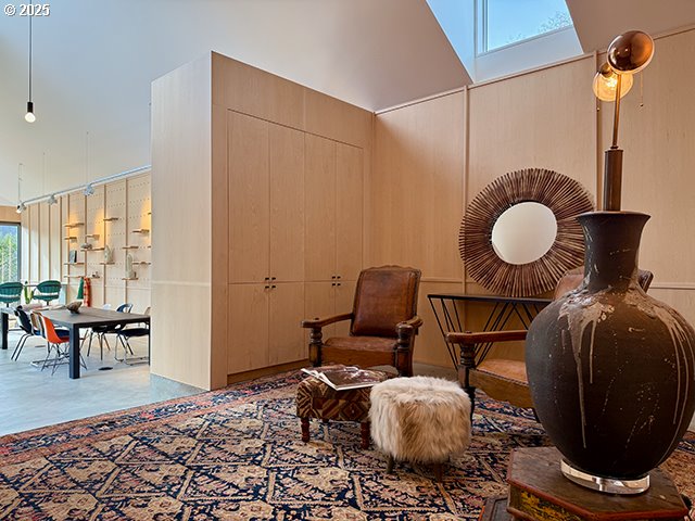 sitting room with a high ceiling and a skylight