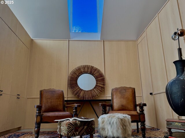 sitting room with high vaulted ceiling