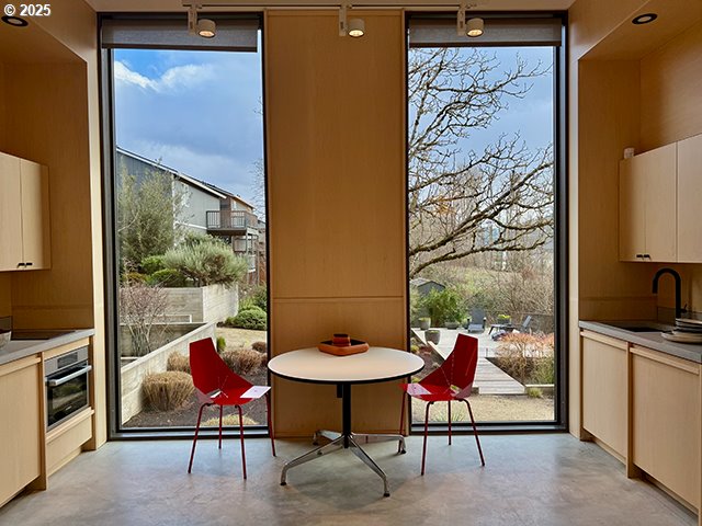 interior space featuring expansive windows, concrete floors, and a sink