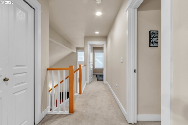 corridor with carpet, recessed lighting, baseboards, an upstairs landing, and vaulted ceiling