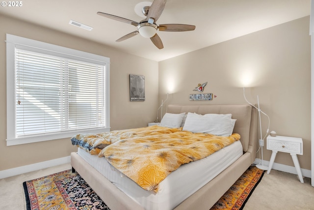 bedroom featuring carpet floors, multiple windows, and baseboards