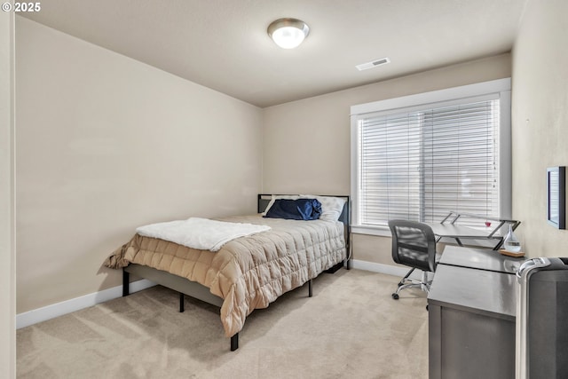 bedroom with light carpet and baseboards