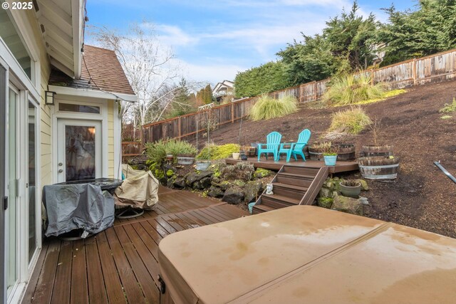 wooden terrace with a fenced backyard and a patio area