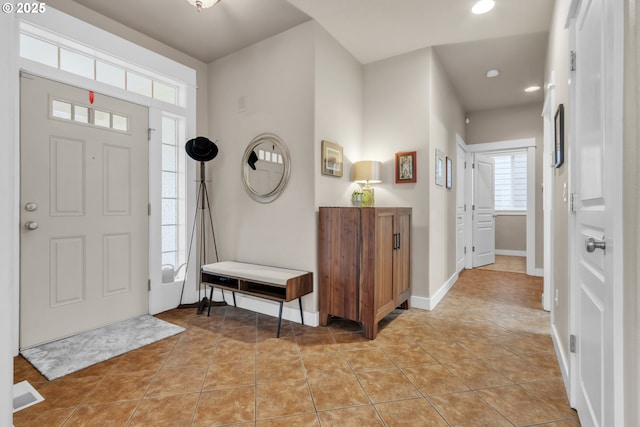 entryway with recessed lighting, baseboards, and light tile patterned floors