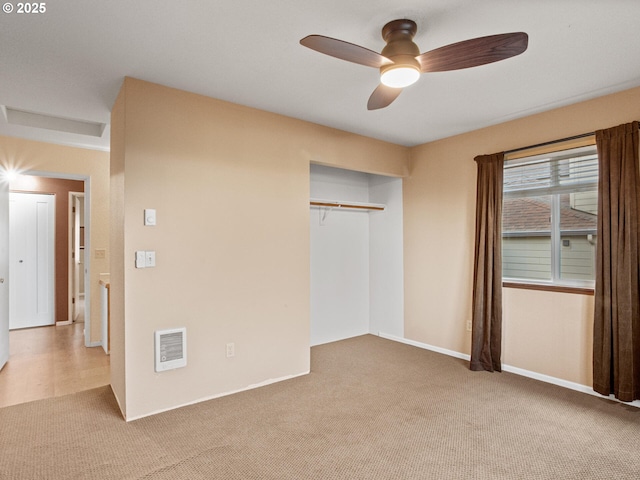 unfurnished bedroom featuring a closet, ceiling fan, and light colored carpet