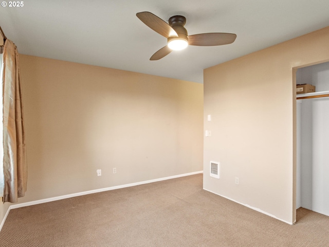 unfurnished bedroom featuring ceiling fan, a closet, and light carpet