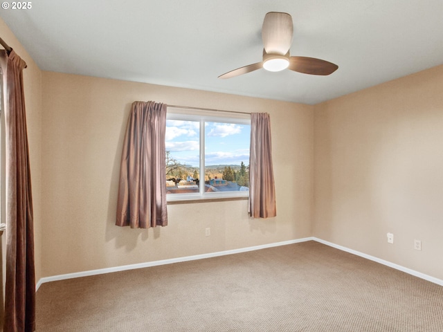 empty room featuring ceiling fan and carpet floors