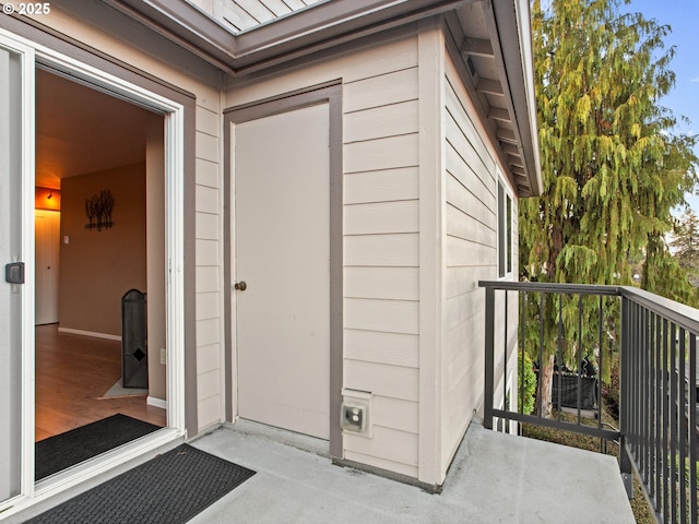 view of exterior entry featuring a balcony