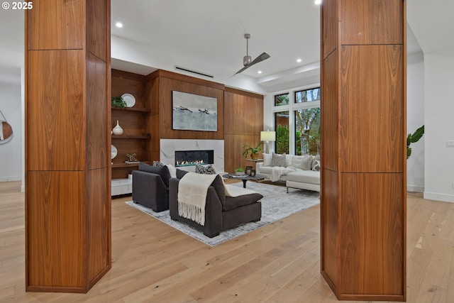 living room with light wood-type flooring and a premium fireplace