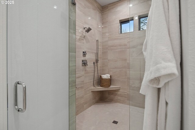 bathroom featuring a shower with shower door