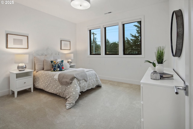 bedroom featuring light carpet