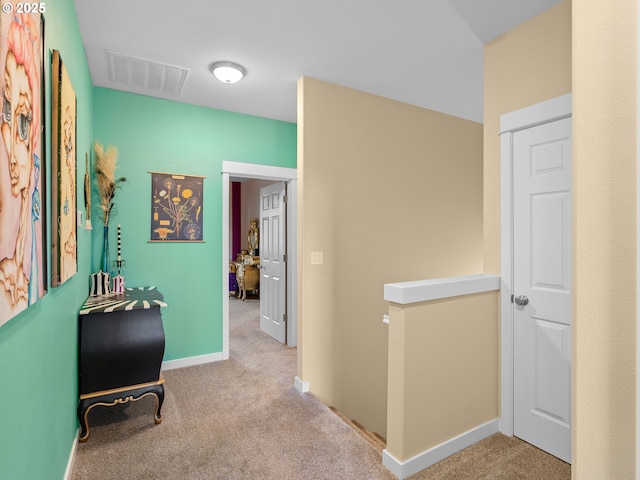 hallway with light colored carpet