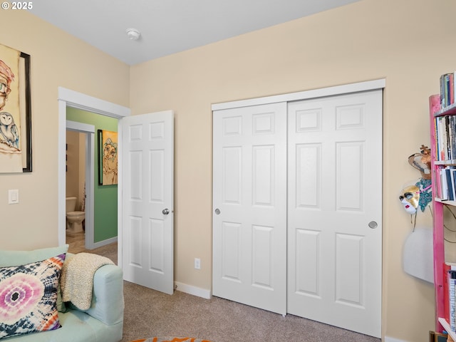 bedroom with carpet flooring and a closet