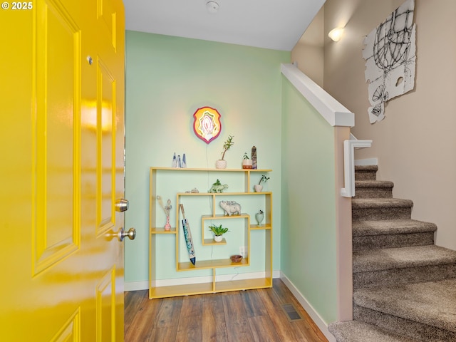 stairway featuring wood-type flooring