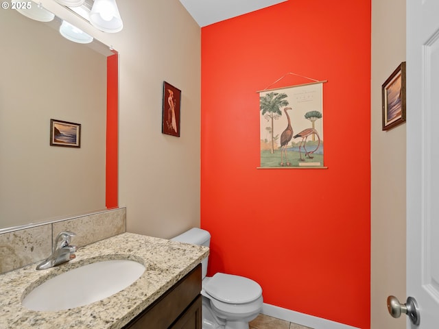 bathroom with tile patterned flooring, vanity, and toilet