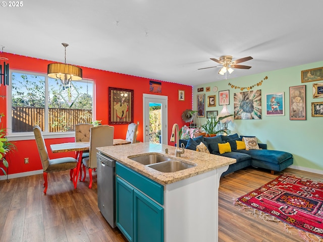 kitchen featuring sink, decorative light fixtures, a center island with sink, dark hardwood / wood-style floors, and dishwasher