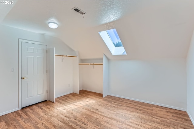 10939 SE Valley Way, Happy Valley, OR 97086 - additional living space featuring a skylight, light wood finished floors, and vaulted ceiling