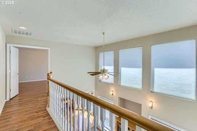 10939 SE Valley Way, Happy Valley, OR 97086 - corridor with a textured ceiling, an upstairs landing, and wood finished floors