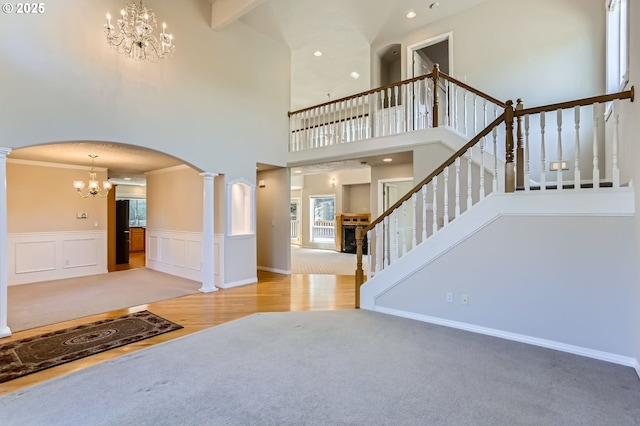 10939 SE Valley Way, Happy Valley, OR 97086 - entrance foyer with a chandelier, arched walkways, ornate columns, a high ceiling, and stairs