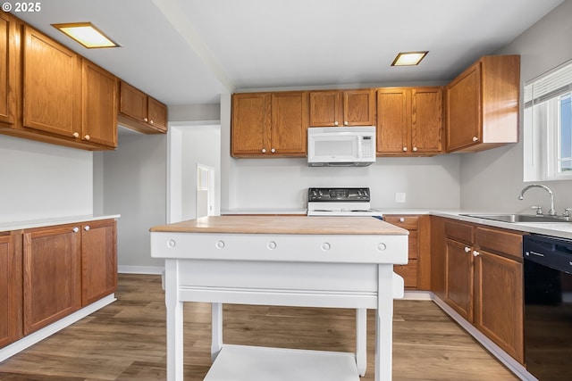 kitchen featuring range with electric cooktop, dishwasher, sink, and light hardwood / wood-style flooring