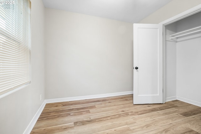 unfurnished bedroom featuring a closet and light hardwood / wood-style flooring