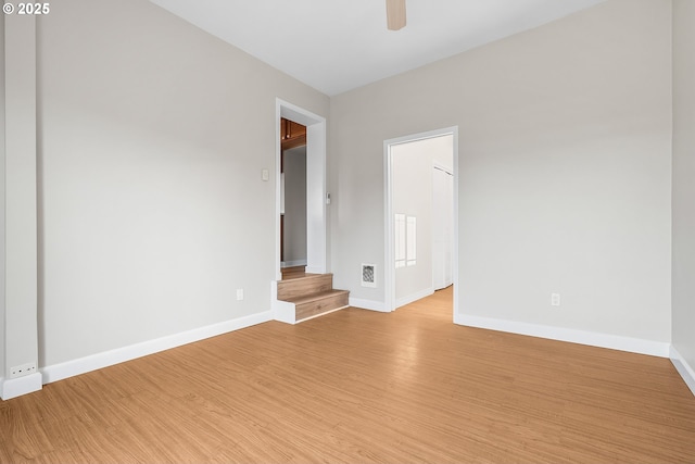 spare room with ceiling fan and light wood-type flooring