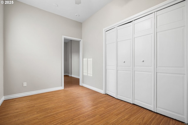 unfurnished bedroom featuring a closet and light wood-type flooring