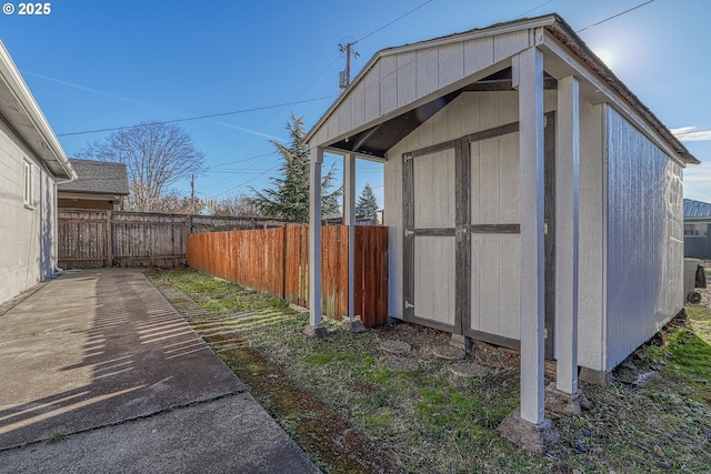 view of shed featuring fence