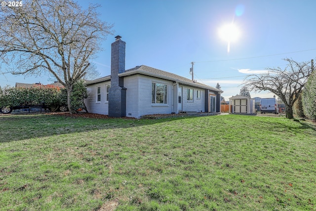 back of property featuring a storage shed and a lawn